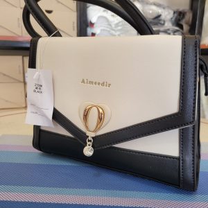 Gold-tone heart-shaped twist lock closure and a top handle handbag