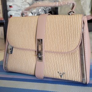 Small sized handbag with a textured finish and a central metal closure